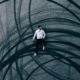 man lying on road with burnout marks