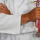 PMHNP standing holding stethoscope with arms folded