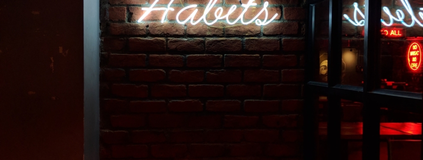 neon sign reads "bad habits"