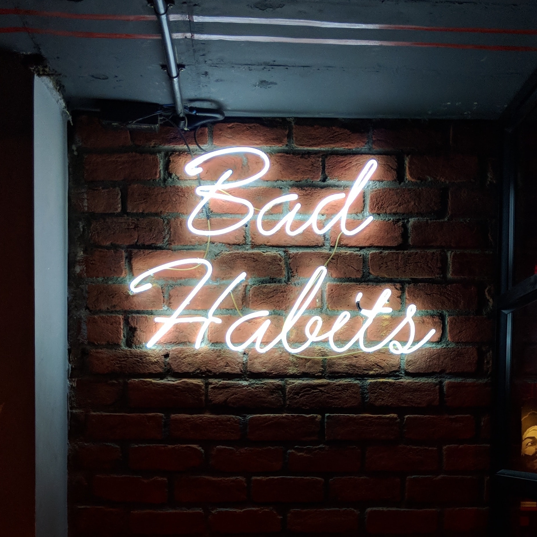 neon sign reads bad habits