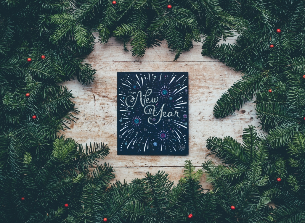 New Years sign surrounded by pine boughs