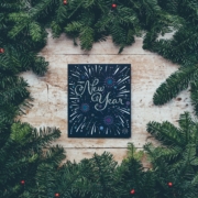 New Years sign surrounded by pine boughs