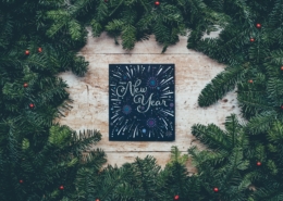 New Years sign surrounded by pine boughs