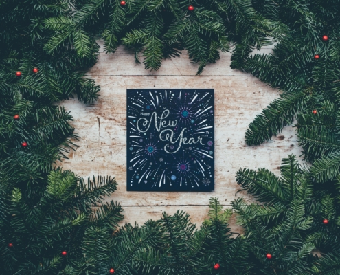 New Years sign surrounded by pine boughs