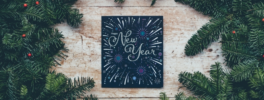 New Years sign surrounded by pine boughs